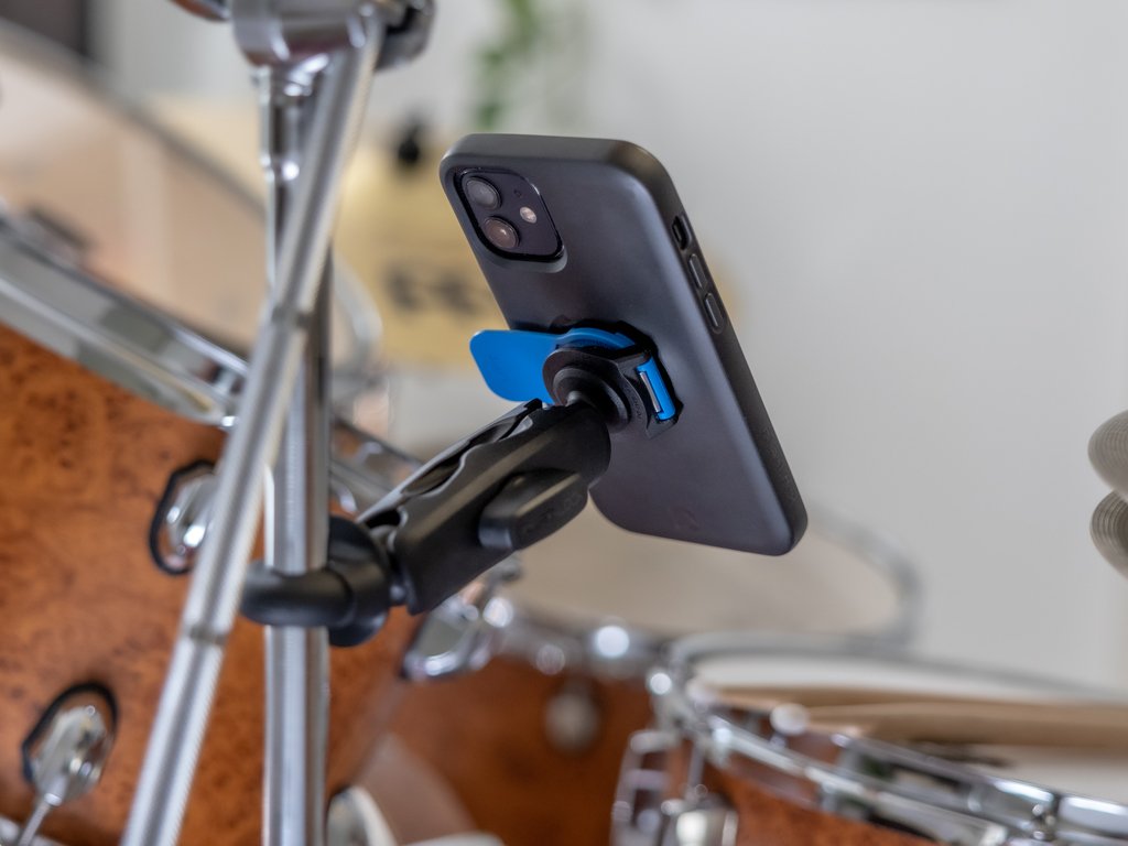 smartphone mounted onto drum kit while playing music