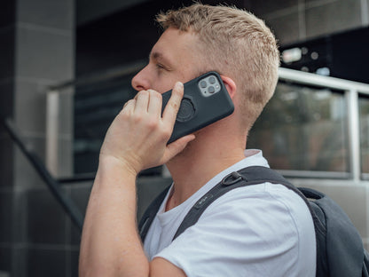 Person on phone with iPhone 11 Pro and Quad Lock Case