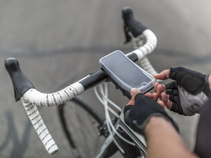 placing poncho on smartphone with quad lock case